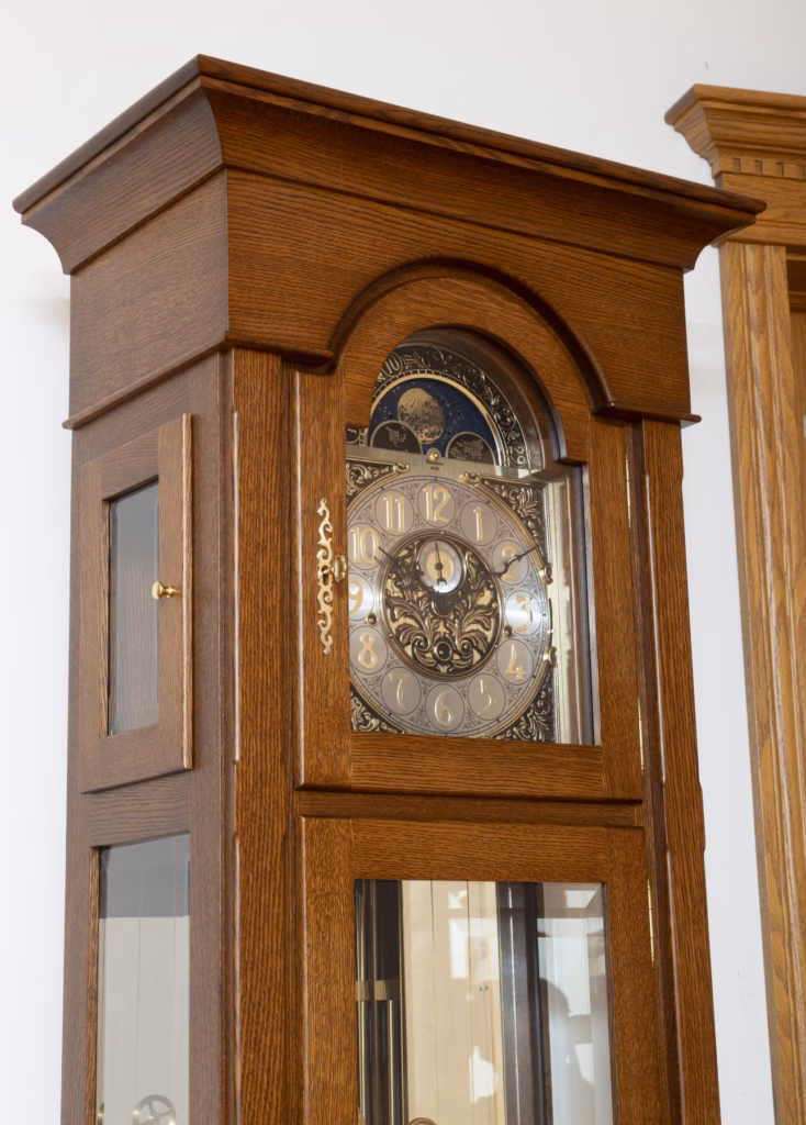 Hood and moon phase dial of a quarter-sawn white oak grandfather clock