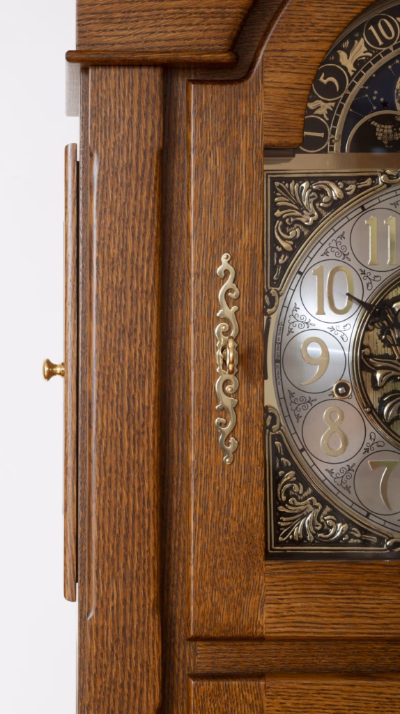 Brass pull knob on hinged upper side door of a grandfather clock